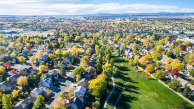 aerial photograph of a colorado neighborhood with mountains in the distance